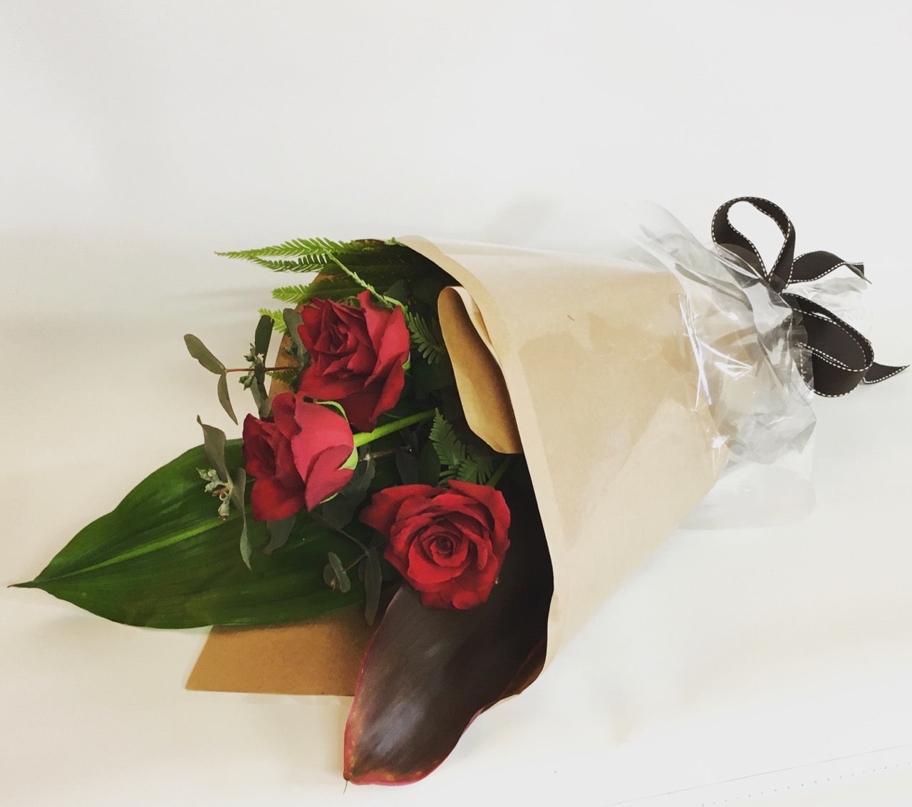 3 Red roses with greenery gift wrapped for delivery on the Sunshine Coast