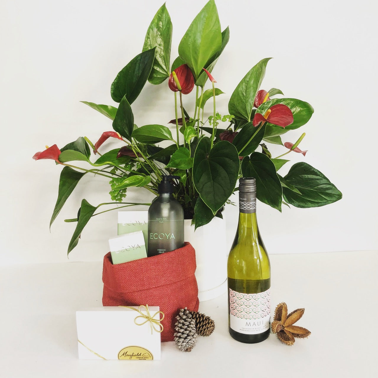 1 anthurium plant, 1 reed diffuser, 1 hand and body wash, 2 bars of 50g chocolate and one bottle of white wine.