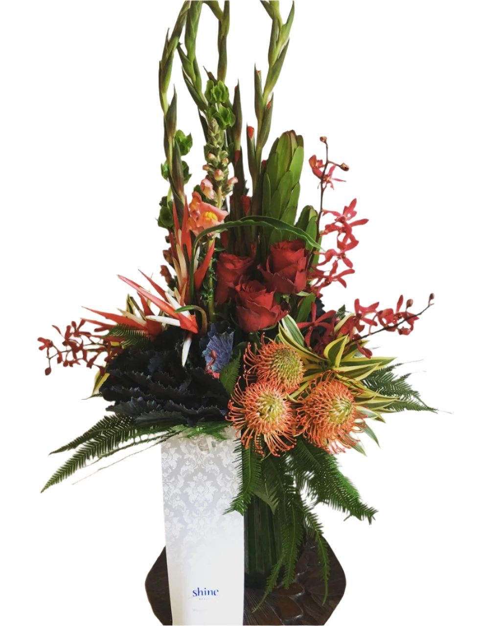 large striking arrangement of warm toned flowers in a vase for delivery on the Sunshine Coast