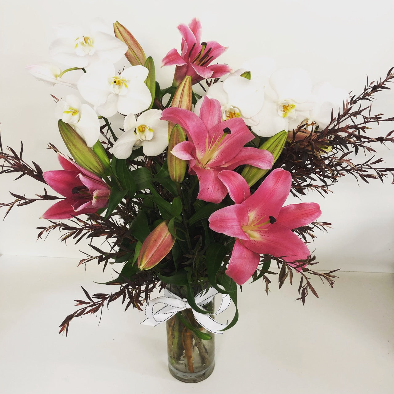 vase of lilies and orchids