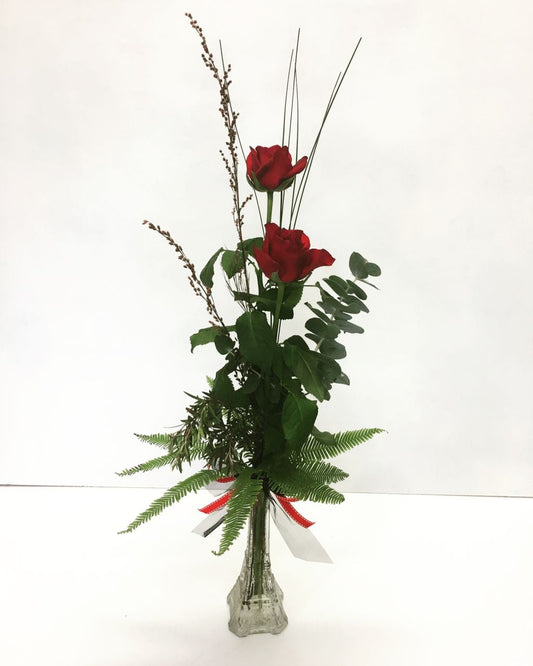 2 roses in a vase with greenery