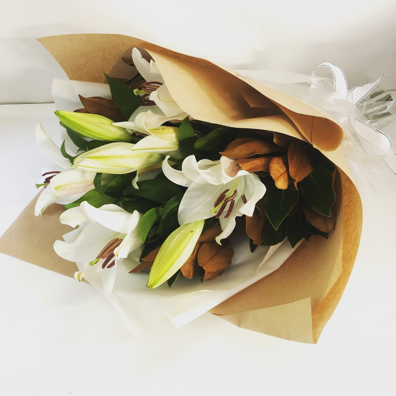 white lilies gift wrapped for delivery on the sunshine coast