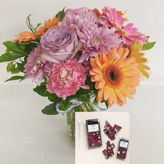 Posy of flowers in a jar and a 50g bar of chocolate