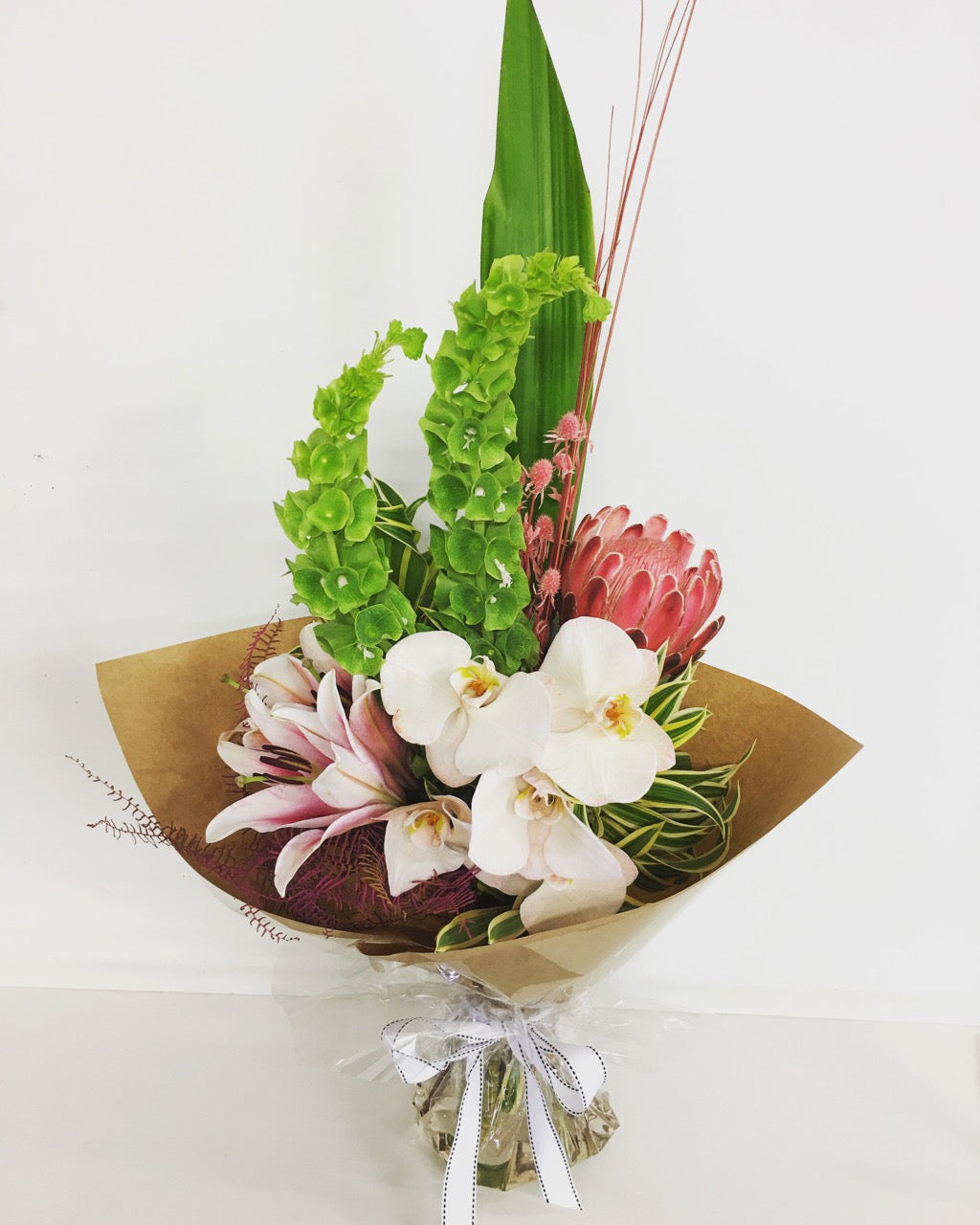 Modern tall flower bouquet gift wrapped in soft colors
