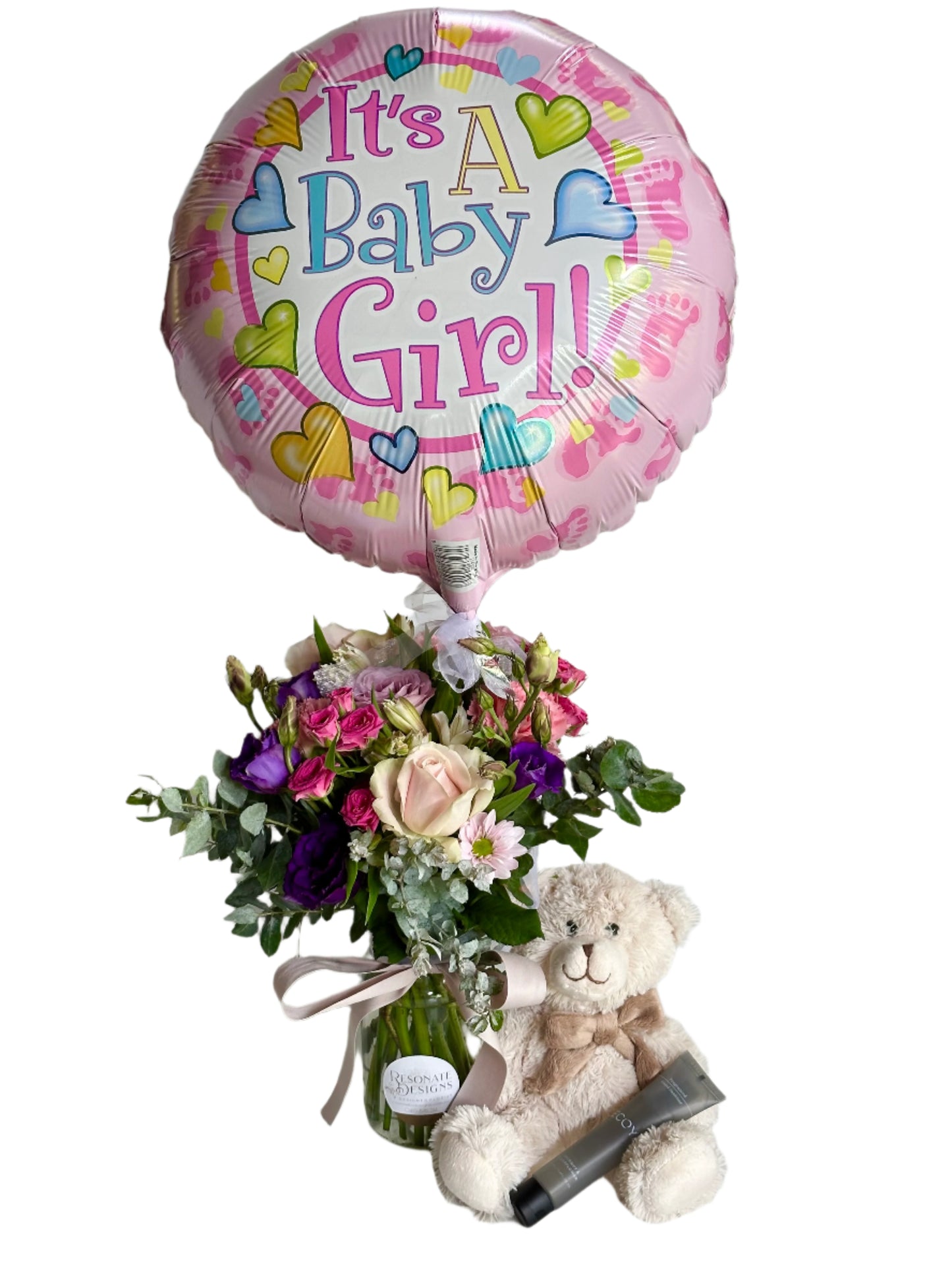 baby gift set with jar of flowers, balloon, neutral coloured teddy, and scented hand sanitiser.