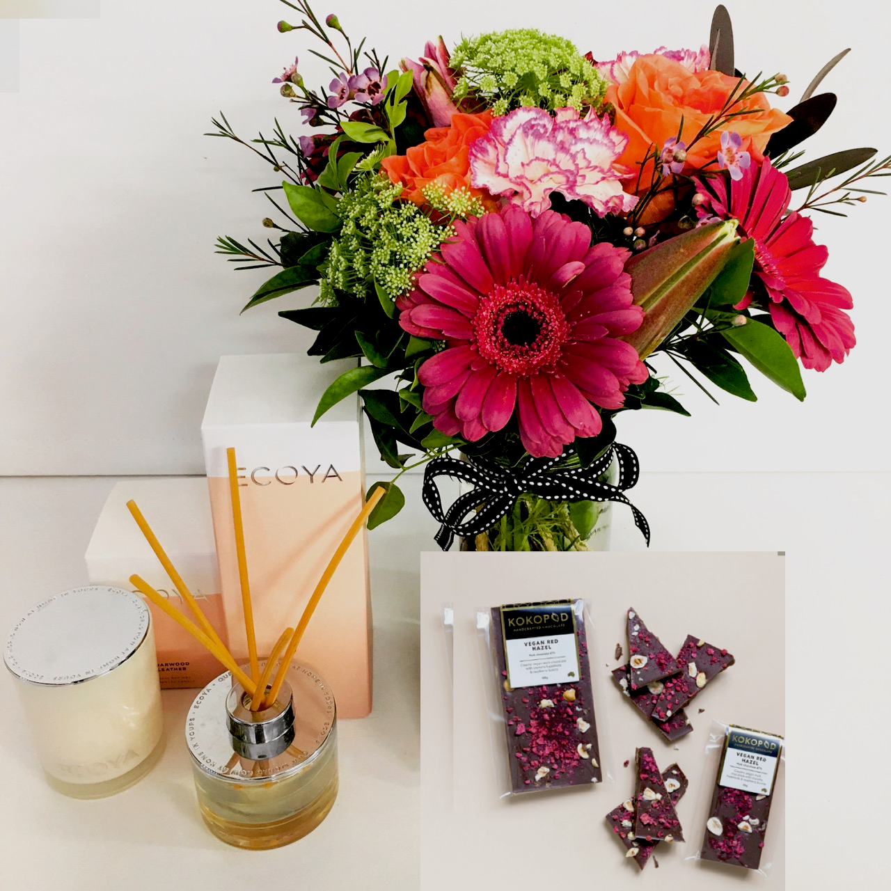 Posy of flower in a jar with reed diffuser, candle and two bars of chocolate for delivery on the Sunshine coast 