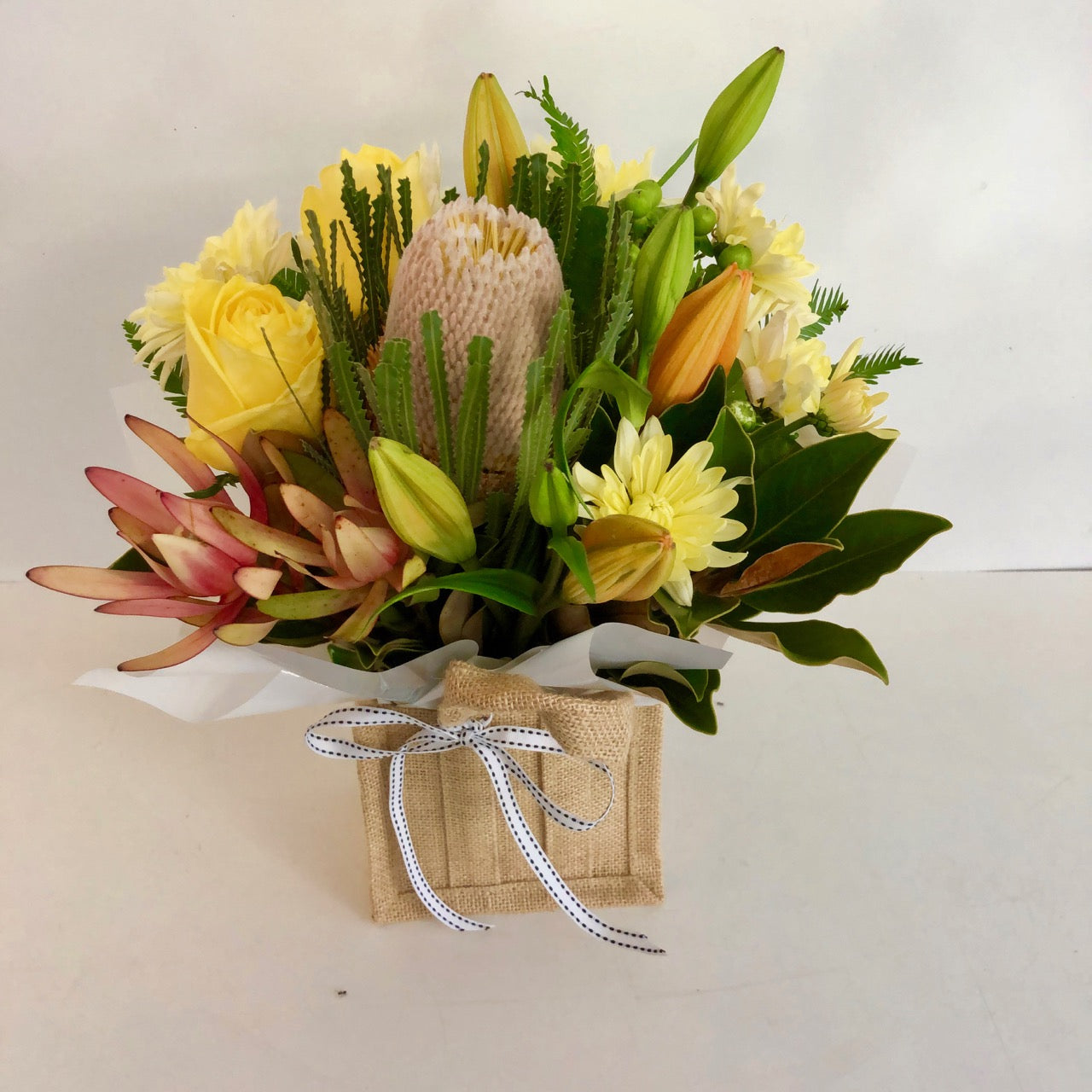 flowers in a hessian bag warm colors for delivery on the Sunshine coast 