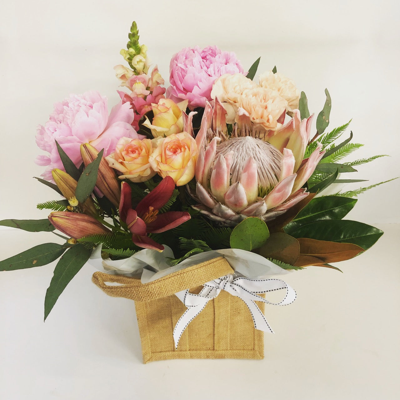 flowers in a hessian bag in soft colors for delivery on the Sunshine Coast 